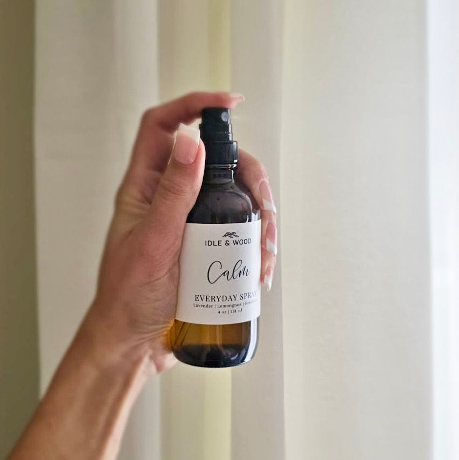 Hand holding 'Calm' against a neutral background