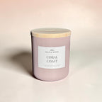 Candle labeled 'Coral Coast' by Idle & Wood on a beige background