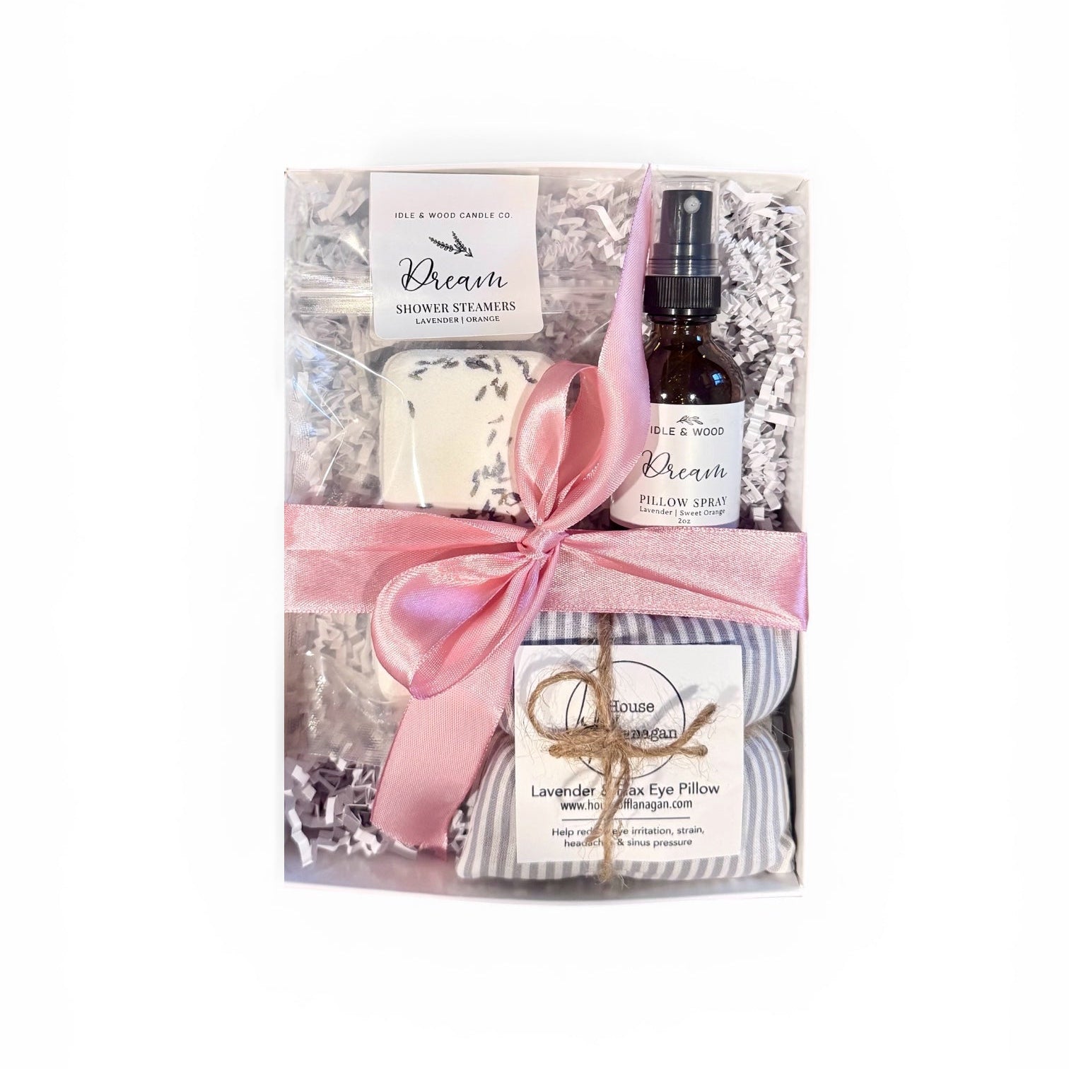 Gift set with products in gift box and tied with a pink ribbon on a white background
