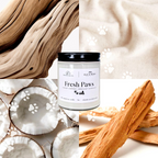 Jar of 'Fresh Paws' product surrounded by wooden elements and coconuts on a textured background